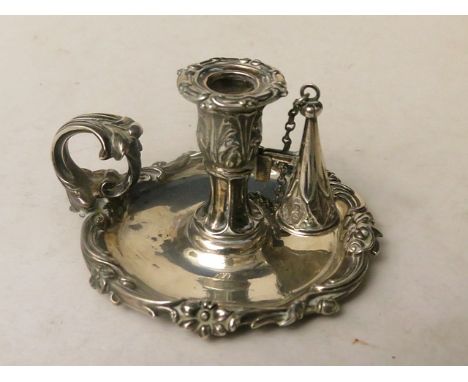 A 19th century small silver chamber stick with cast rococo style borders