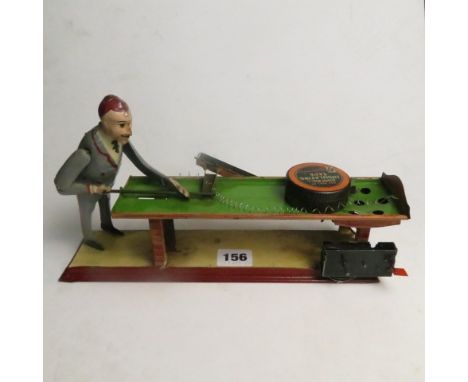 An Edwardian clockwork tin plate model toy of a bagatelle player, with key A/F