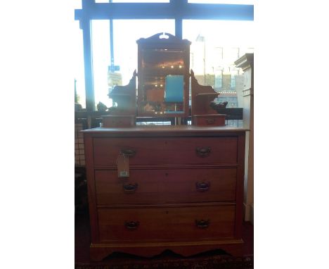 An Edwardian pine dressing chest of three long drawers, with mirror and superstructured top, raised on bracket supports 