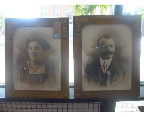 A pair of early 20th Century signed portrait prints, glazed and with in Arts and Crafts leaf decorated gilt frames, H. 62cm  