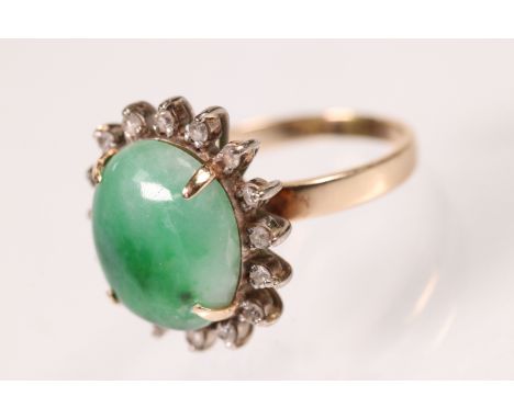 14ct gold, jade and diamond ring. The ring set with an oval jade cabochon with a halo of round cut diamonds. Marked 585 to sh
