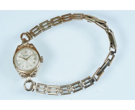 9ct gold Rotary ladies wrist watch having a round face with arabic numerals to the chapter ring set to a gate link bracelet s