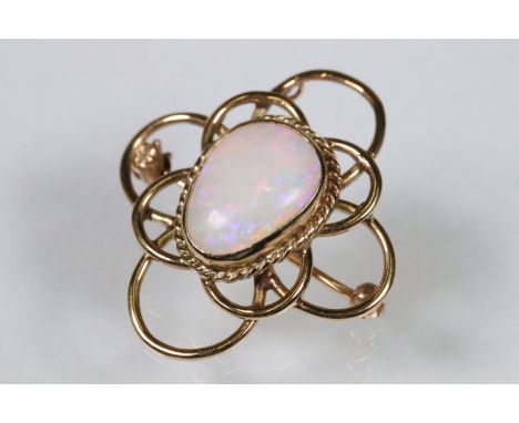 20th Century opal and yellow metal brooch. The brooch being set with a polished opal panel to the centre within a pierced mou