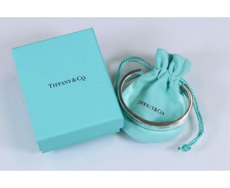 Tiffany &amp; Co silver open bangle complete with original box. Marked 925 T &amp; Co. Measures 6cm wide.
