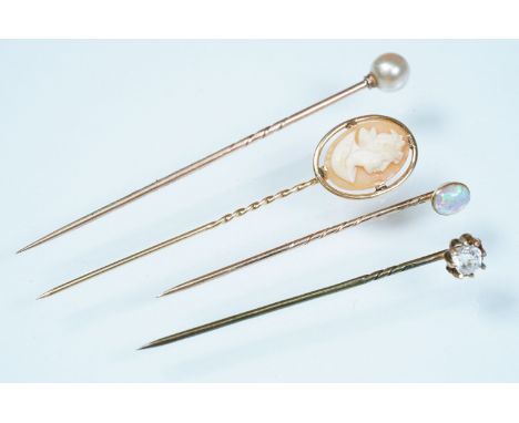 Collection of 19th Century stick pins to include an opal cabochon pin, cultured pearl pin, carved shell cameo pin and a gold 