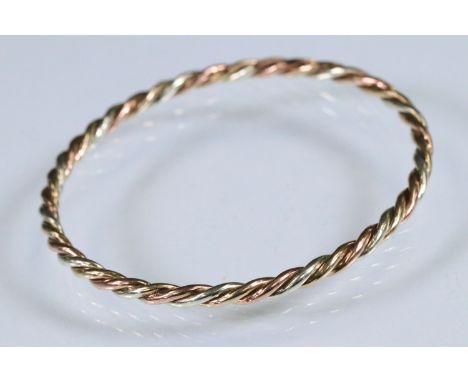 Tri tone metal twist design bangle bracelet. Unmarked, tests indicate 9ct gold. Measures 6.4cm.