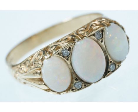9ct gold opal and diamond ring. The ring being set with three oval opal cabochons with diamond accent stones. Hallmarked Lond