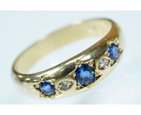 15ct gold, sapphire and diamond ring. The ring being set with three round cut sapphires with diamond accent stones. Marked 58