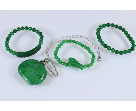 Group of three jade beaded bracelets to include one with a carved horse bead, and another with a carved panel bead, together 