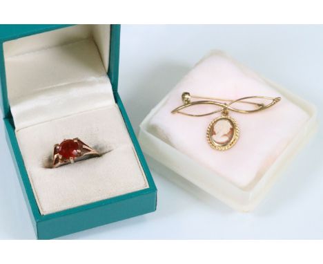 9ct gold and citrine ring together with a 9ct gold cameo brooch. The ring set with a round step cut orange citrine on a split
