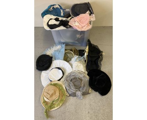A large tub of assorted vintage and theatrical hats in varying colours and styles. 