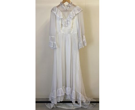 A vintage 1970's frill sleeved high necked wedding dress with small train. With V shaped frill detail to bodice front and bac