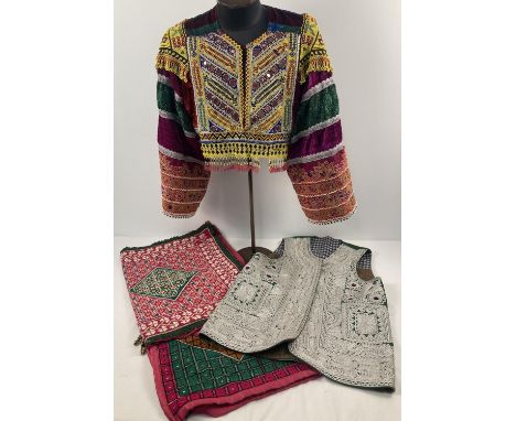 A collection of vintage Central Asian clothing and textile items. To include a heavily beaded and embroidered short length to