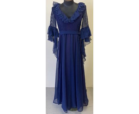 A vintage 1970's Jean Varon midnight blue long sleeved chiffon evening dress. With pleated detail, ruffle V neck and long tie