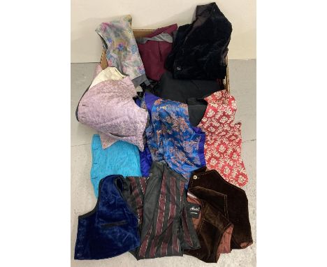 A box of assorted vintage men's waistcoats in various designs and sizes. 
