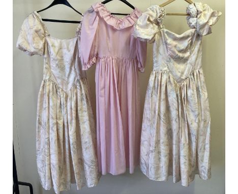 3 vintage 1980's bridesmaids dresses in peach and pink tones. 2 matching drop waist dresses with puffed sleeves together with