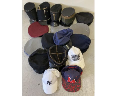 A box of assorted vintage and costume peaked hats and caps. 