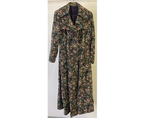 A women's vintage 1970's tapestry style full length coat with winged collar and button fastening. 
