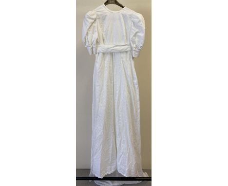 A vintage 1960's broderie anglaise empire line short sleeved wedding dress with long bow and train to back. Zip needs attenti