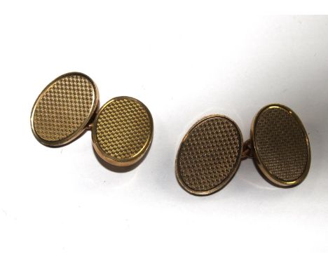 A pair of 9 carat gold oval cuflinks with engine turned decoration 