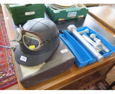 A vintage motorcycle helmet and googles, various torches, voltmeters and other gauges 