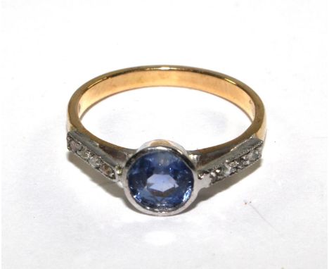 An 18 carat gold ring set with central sapphire and diamond shoulders 