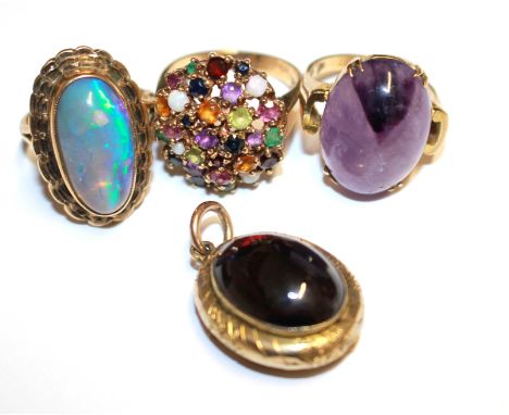 A ladies gold ring set with emeralds, ruby, peridot, amethyst together with two more rings and a garnet pendant, as found