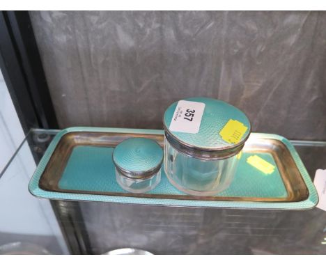 A dressing table set consisting of a silver and turquoise enamel tray and two glass jars with silver and enamel 