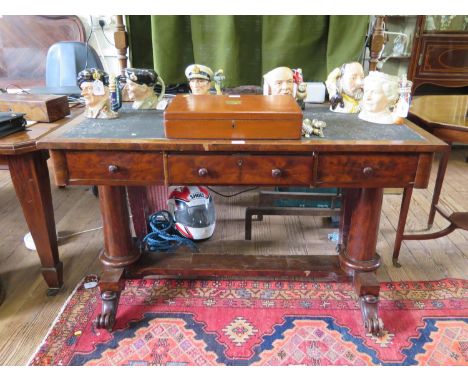 An Early Victorian mahogany library table, the rectangular inset top over three frieze drawers on barrel turned supports join