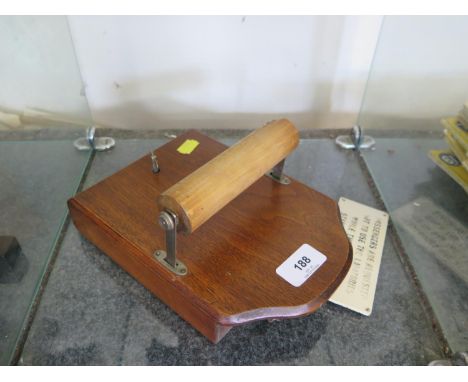 A French mahogany novelty toilet roll holder, with clockwork music box playing two tunes, and a railway sign (2) 