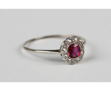 A ruby and diamond cluster ring, collet set with a cushion cut ruby within a surround of cushion cut diamonds, unmarked, ring