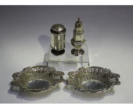 A pair of late Victorian silver oval bonbon dishes, each decorated in relief with scrolling leaf and flower stems above spira