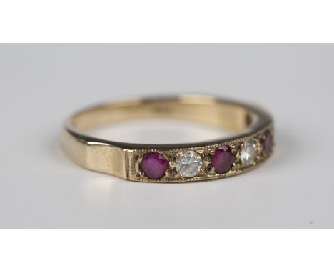 A 9ct gold, ruby and diamond seven stone half-hoop ring, mounted with four circular cut rubies alternating with three circula