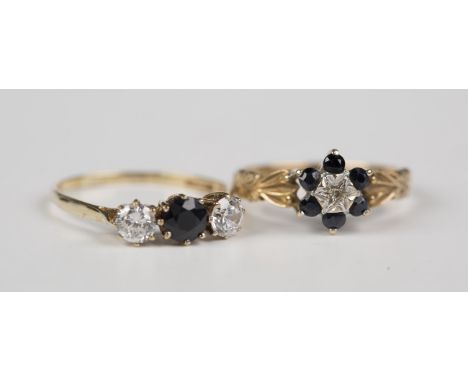 A 9ct gold, sapphire and diamond seven stone cluster ring, mounted with a circular cut diamond within a surround of six circu