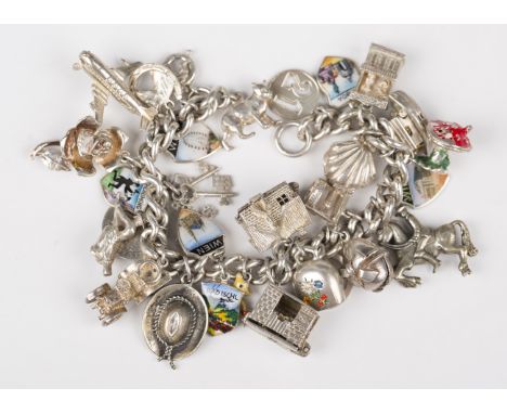 A silver curblink charm bracelet on a boltring clasp, fitted with a variety of mostly silver charms, including an aeroplane, 