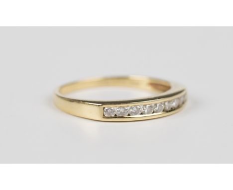 An 18ct gold and diamond ring, mounted with a row of nine circular cut diamonds in a channel setting, import mark Birmingham 