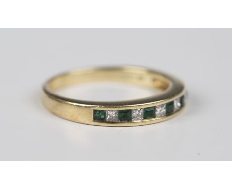 An 18ct gold, emerald and diamond half-eternity ring, mounted with seven square cut emeralds alternating with six princess cu