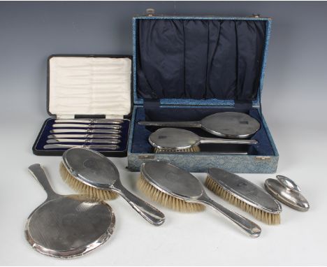 A George VI silver three-piece engine turned dressing table set, comprising hand mirror, hairbrush and comb, Birmingham 1946 