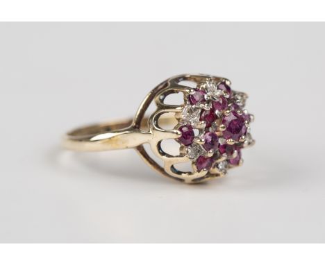 A 9ct gold, ruby and diamond star shaped cluster ring, mounted with six circular cut diamonds, otherwise set with circular cu