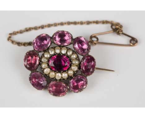 A gold cased, seed pearl and pink foil-backed gem set shaped oval brooch, first quarter of the 19th century, fitted with a sa