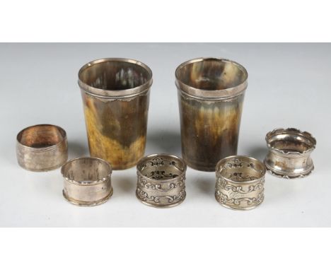 A pair of silver mounted horn beakers, height 9cm, a pair of Gorham sterling napkin rings and three other silver napkin rings