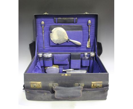 A George V dark blue leather travelling vanity case, detailed 'Mappin &amp; Webb Ltd', the interior fitted with a set of silv