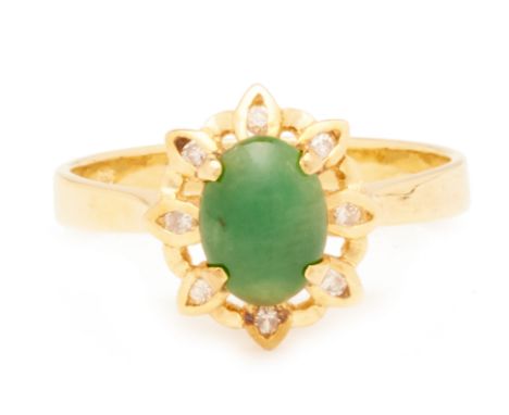 A JADE AND DIAMOND RING
Set in yellow gold, the oval jade cabochon within a surround of round brilliant cut diamonds
Marked '