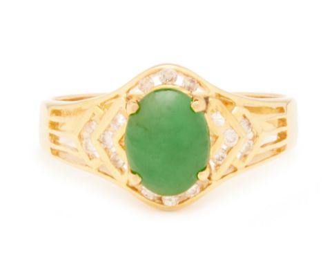 A JADE AND DIAMOND RING In 14K gold, the oval jade cabochon in a stylised openwork diamond setting  Marked "585" US ring size