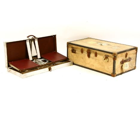 A vintage cased metal picnic set, table and chairs, and an old travel trunk