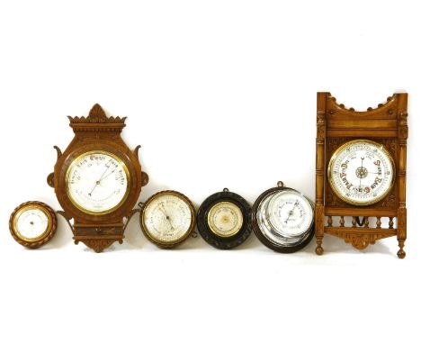 A late Victorian aneroid barometer by D McGregor & Co. Glasgow, the ornate silvered dial 17cm diameter, together with five va