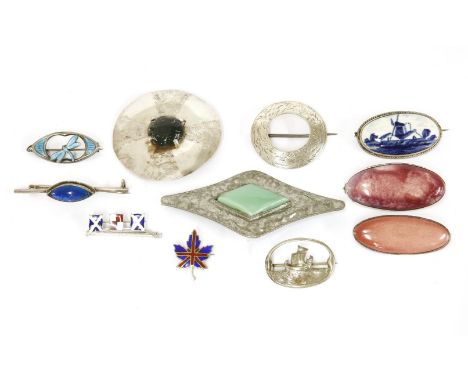 Three Ruskin style brooches, including a pink enamelled ceramic brooch in silver mount, a green diagonal plaque with hammered