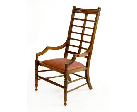 An Aesthetic walnut armchair, with a ladder back and an embroidered drop-in seat