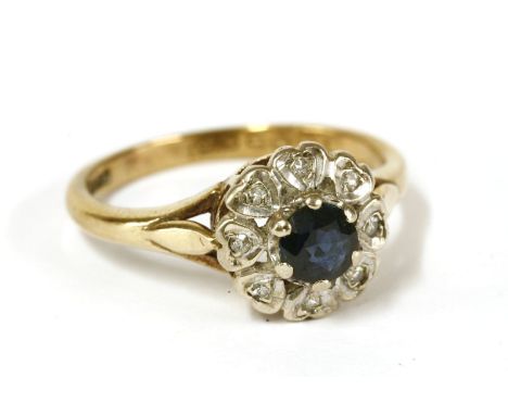 A 9ct gold sapphire and diamond cluster ring, circular cut sapphire, claw set to heart shaped diamond set collets, size N½, 3