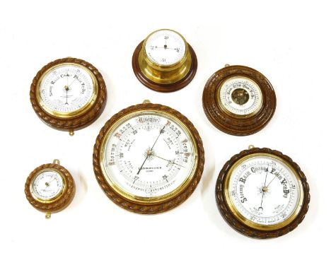 A large aneroid barometer by E Johnson & Sons of Derby, in an oak rope twist case, 32cm diameter, together with five further 